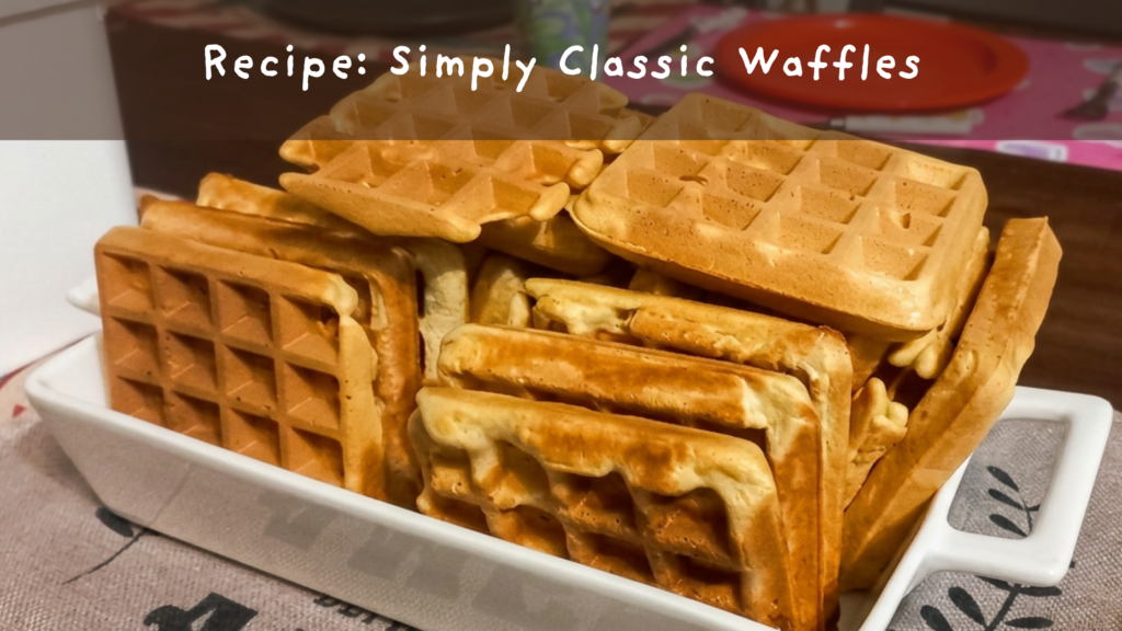 A white rectangular serving dish stacked full of golden-brown, freshly baked classic waffles, with text overlay reading "Recipe: Simply Classic Waffles".